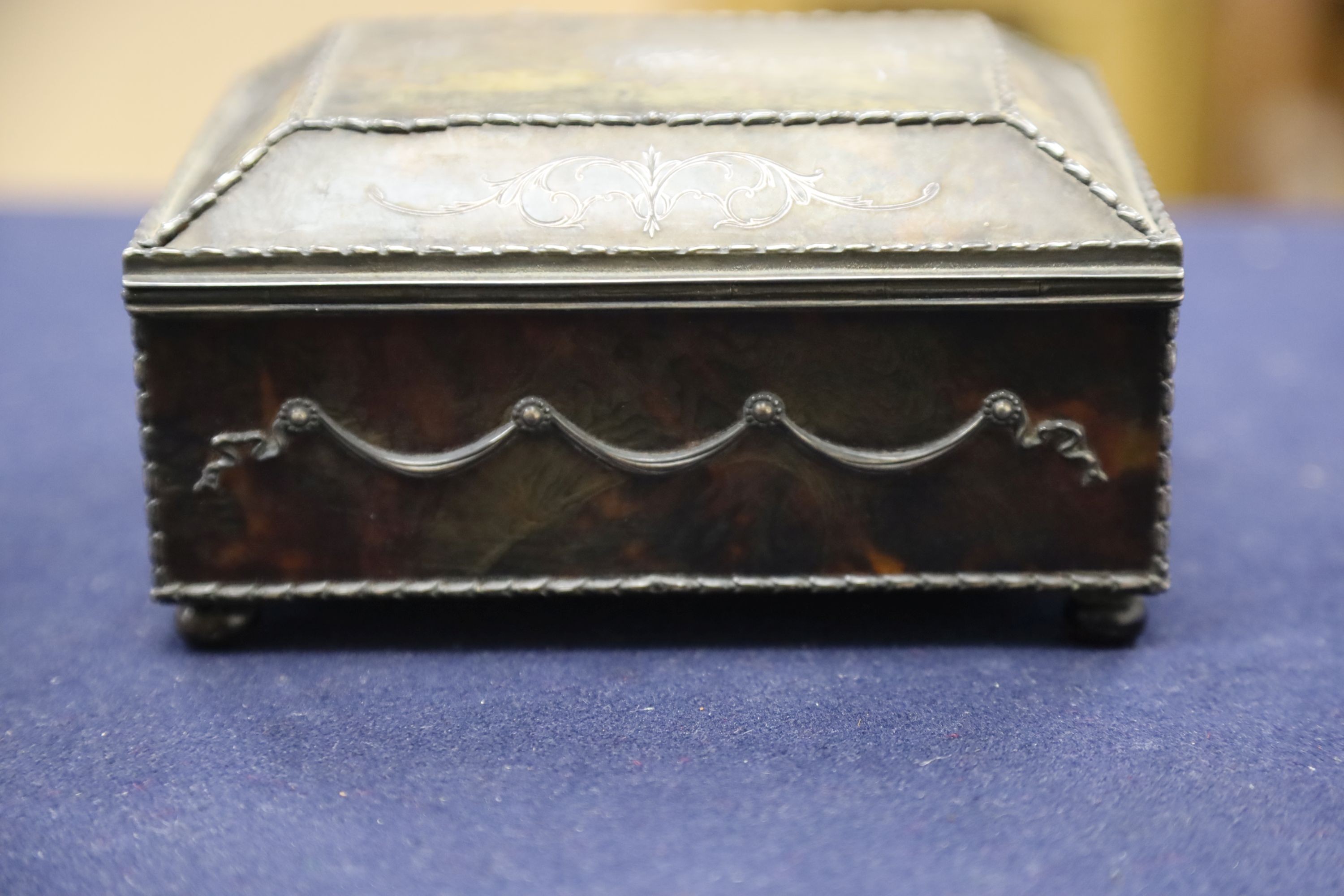 A silver-mounted tortoiseshell pique rectangular trinket box, by William Comyns, raised on four ball feet, London, 1904, width 15cm. 15cm